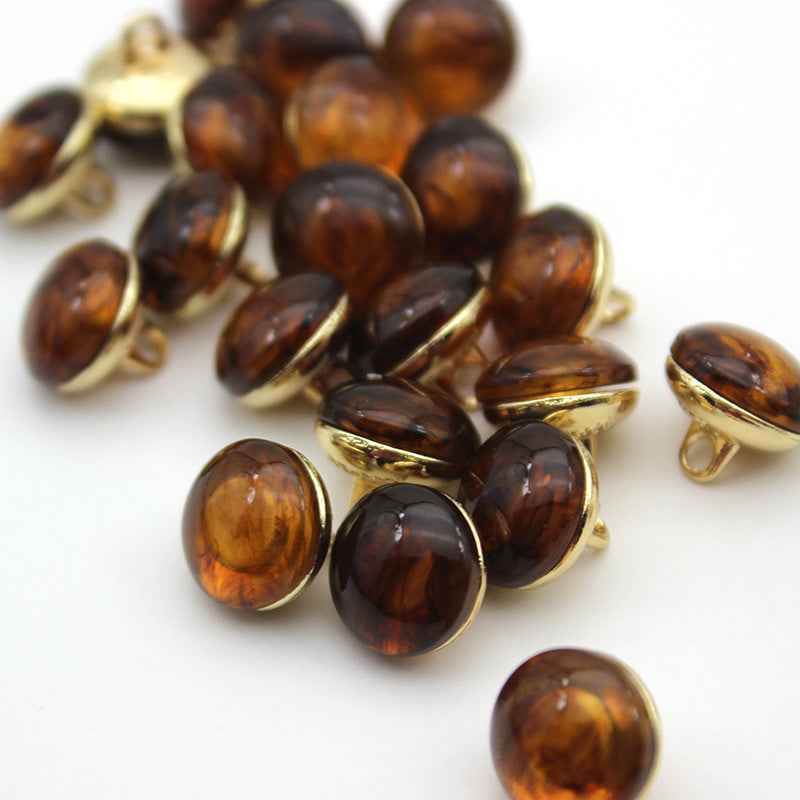 Tortoise amber cat-eye shank buttons with gold loop backs, round, mixed batch