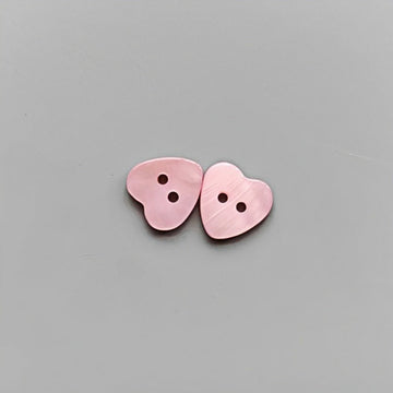 Pink heart-shaped 2-hole shirt buttons for children, two pieces shown.