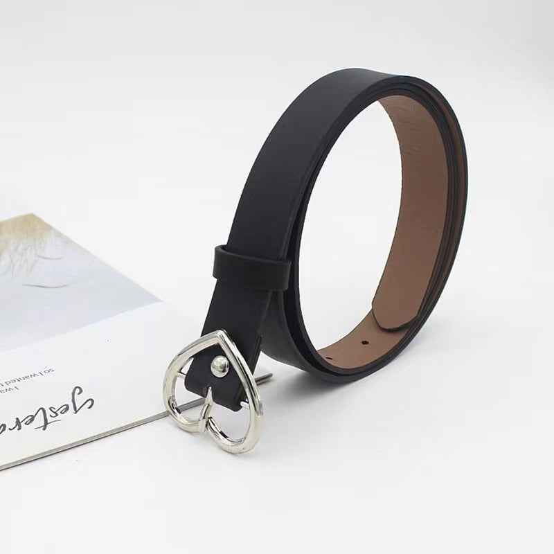 Silver metal roller buckle on black strap, ring hardware close-up