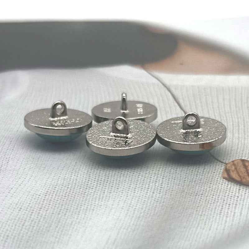Round metal sewing buttons, silver backs with loops for stitching