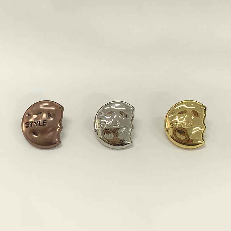 Three semi-circular metal shank buttons: coffee-brown, silver, and gold, each engraved “STYLE”