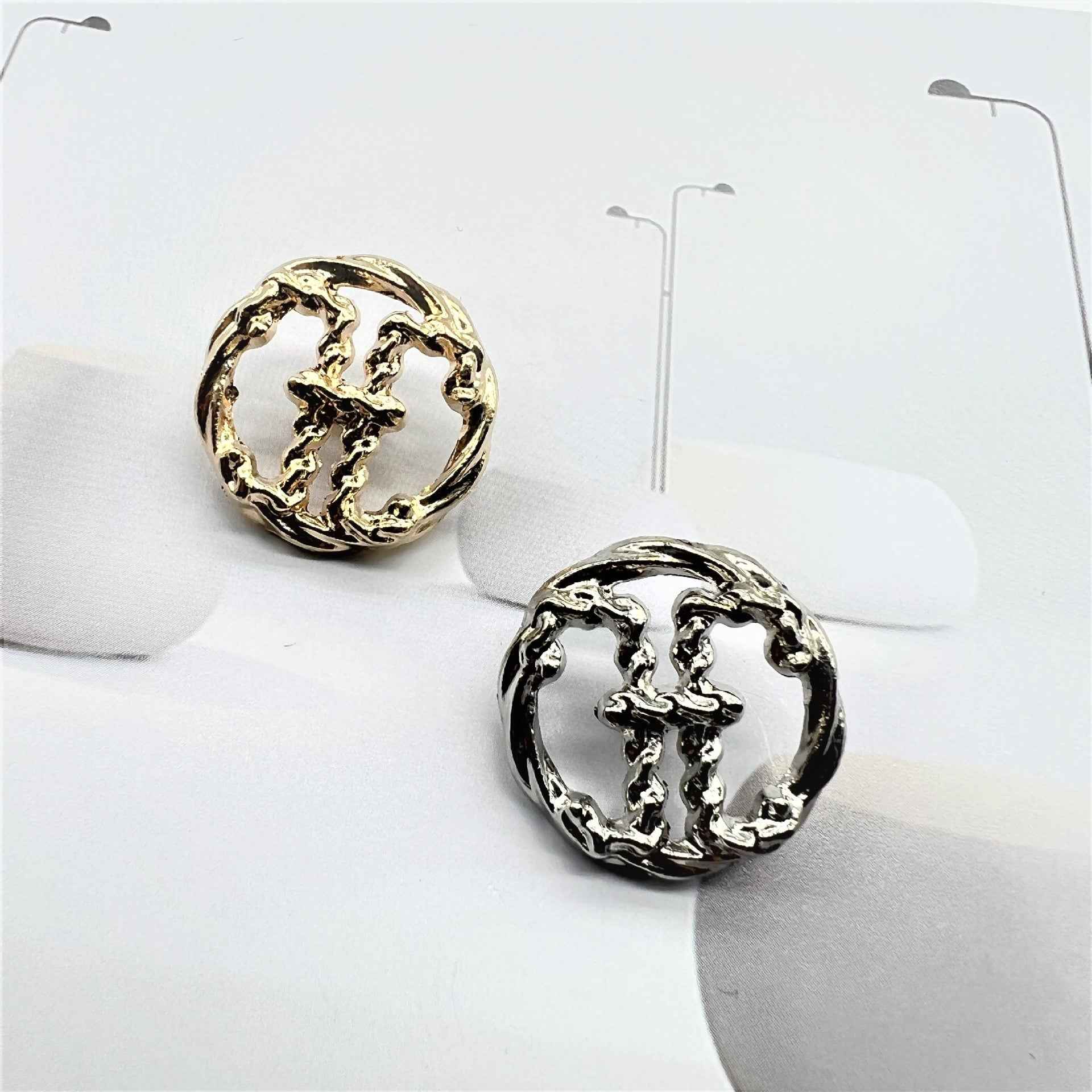 Pair of metal sewing buttons with raised H initial, gold and silver