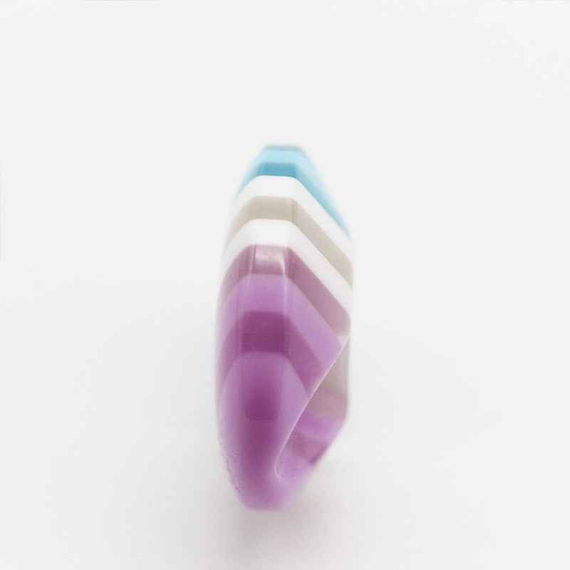 Colorful striped resin button side view, purple and white with light blue stripes