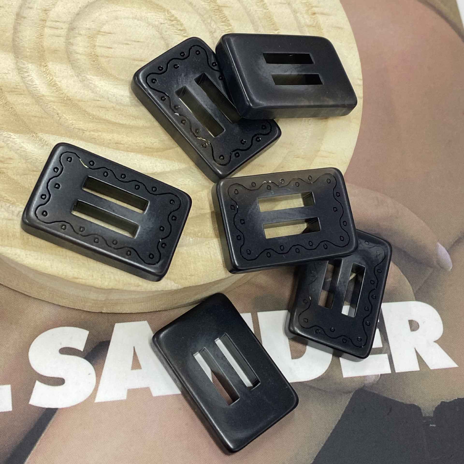 Rectangular resin 2-hole buckle buttons, black, multiple pieces arranged