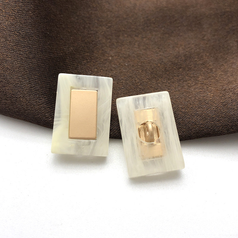 Beige rectangular resin buttons with metal shank, 22mm; two pieces shown