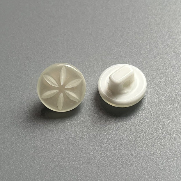 Pearlized resin shank button, light cream, floral embossed front and back