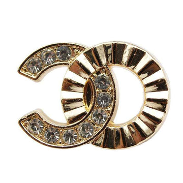 C-shaped metal button with rhinestone row, gold-tone bezel and clear stones