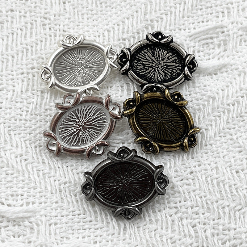 Oval metal shank buttons, engraved floral design in silver, black, bronze, and dark finishes