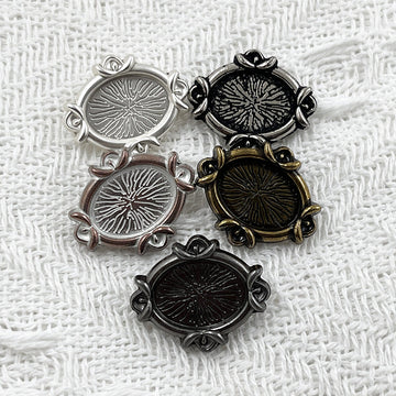 Oval metal shank buttons, engraved floral design in silver, black, bronze, and dark finishes