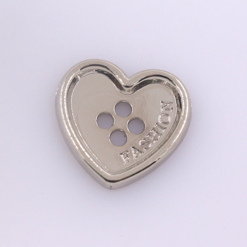 Heart-shaped metal button with four holes, silver tone finish for clothing