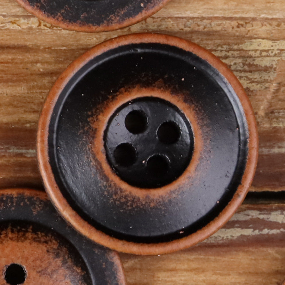 Round 4-hole double-ring button in dark black wood-tone, close-up