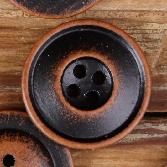 Round 4-hole double-ring button in dark black wood-tone, close-up