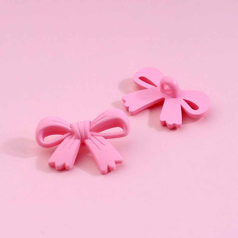 Pink bow-shaped plastic shank buttons with loop shanks, 2-piece view