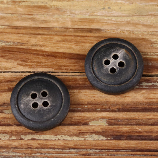 Two dark four-hole natural horn buttons