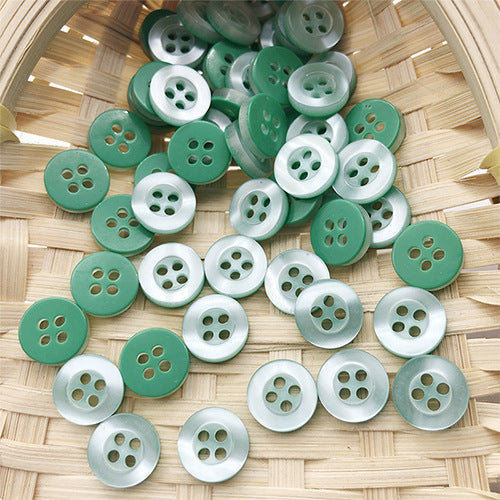 Round 4-hole pearlized resin buttons in teal and white, neatly grouped (10mm)