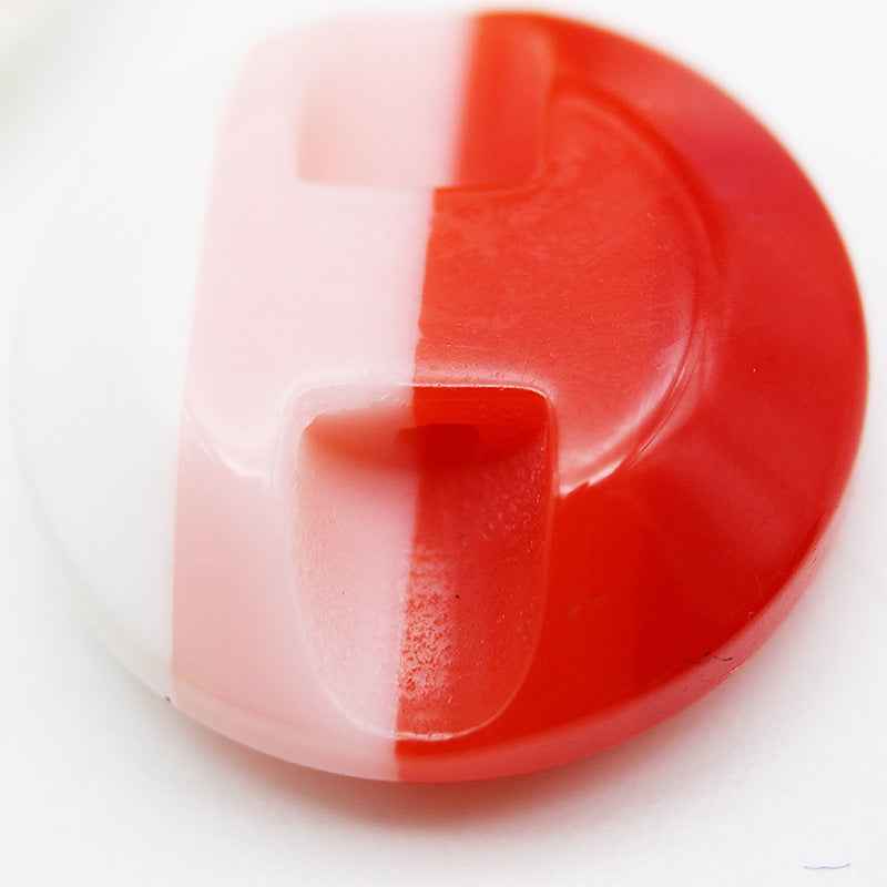 Colorful striped resin button in red with a visible hidden-hole slot