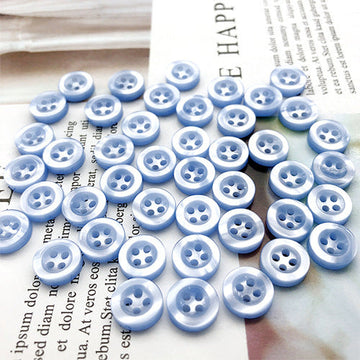 10mm light blue round shirt buttons with four holes, 100-piece pack, many buttons shown