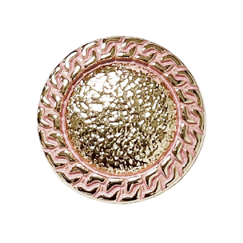 Pink chain-edged round metal button with gold textured center