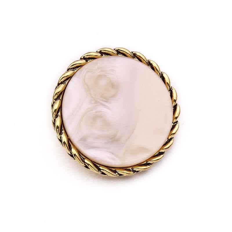 Single round resin button with gold braided edge and pale pink marbled face