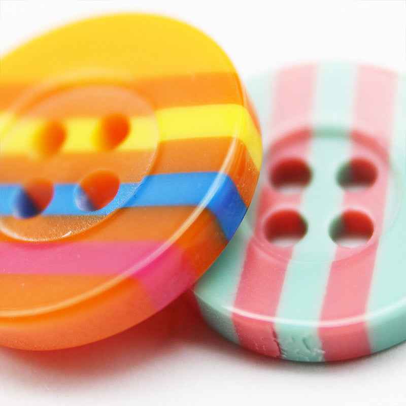 Two colorful 4-hole resin buttons: orange-yellow stripes and pink-mint stripes