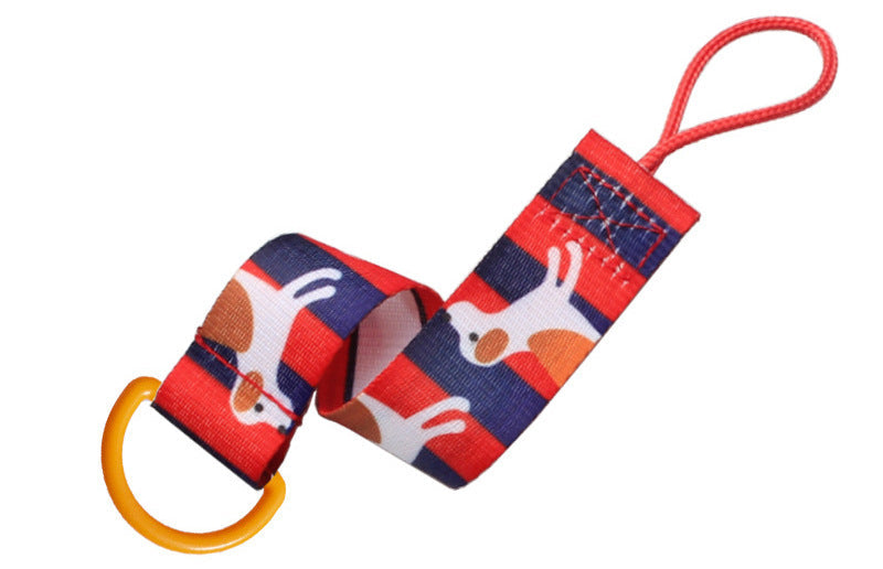 Yellow plastic D-ring buckle attached to a red patterned fabric strap for bags