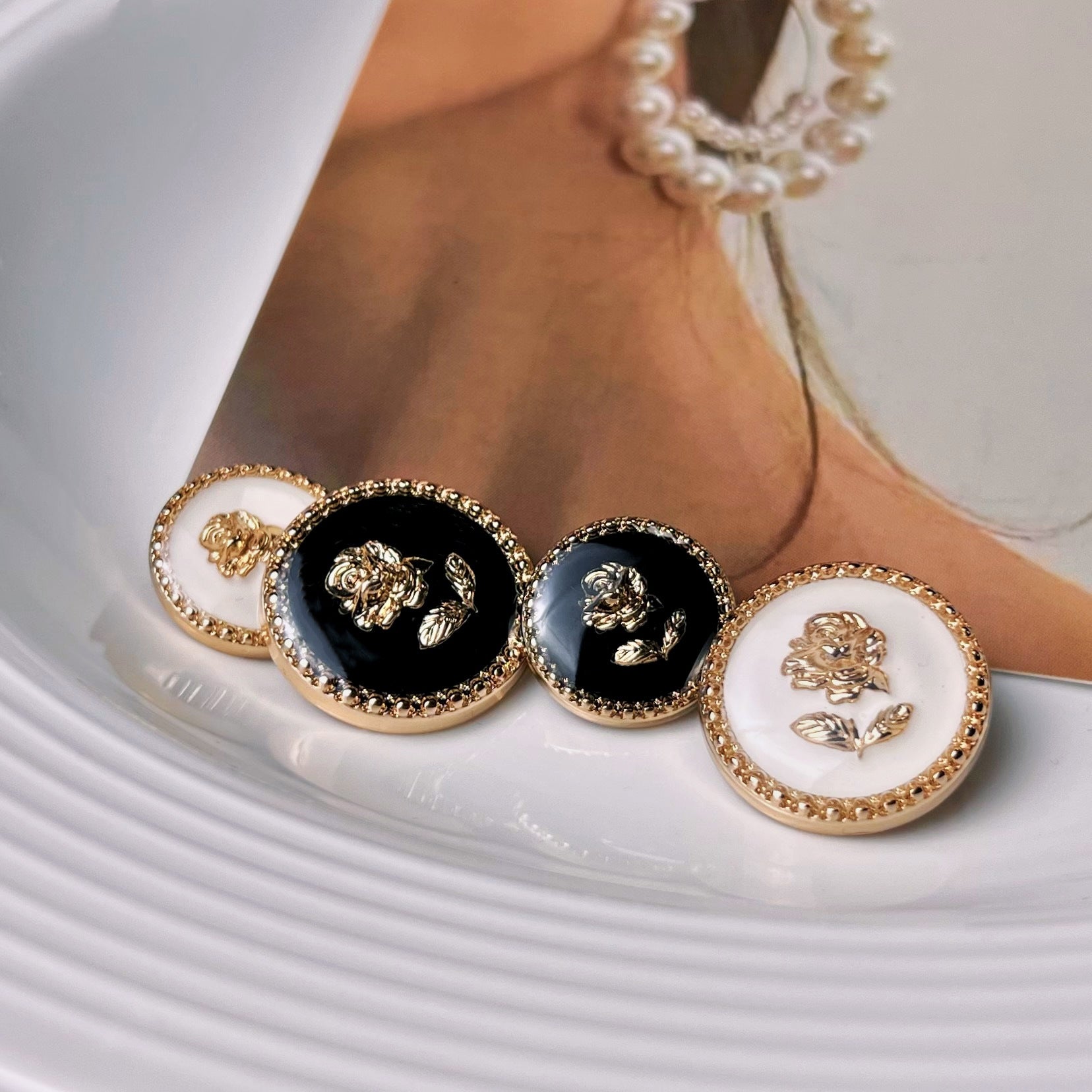 Gold resin rose shank buttons in black and white, shown on garment placket