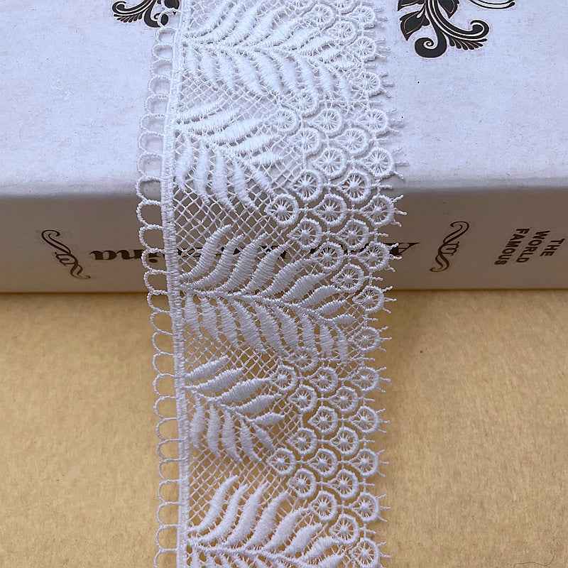 White embroidered leaf lace trim with net background and fringed scalloped edge