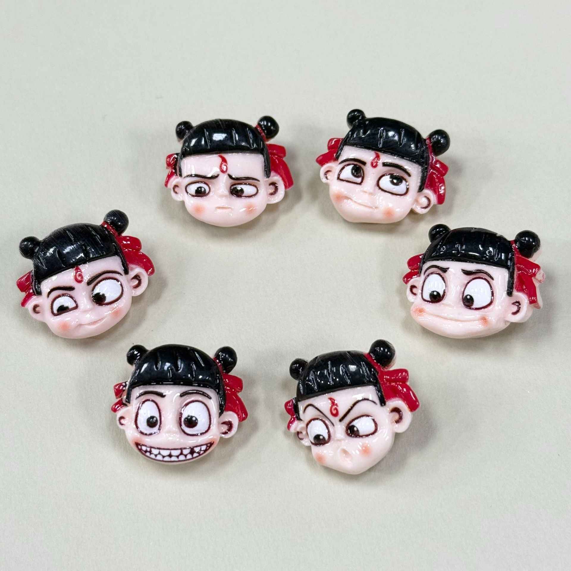 Set of cartoon Nezha emoji face buttons, mixed expressions, black hair, red bows