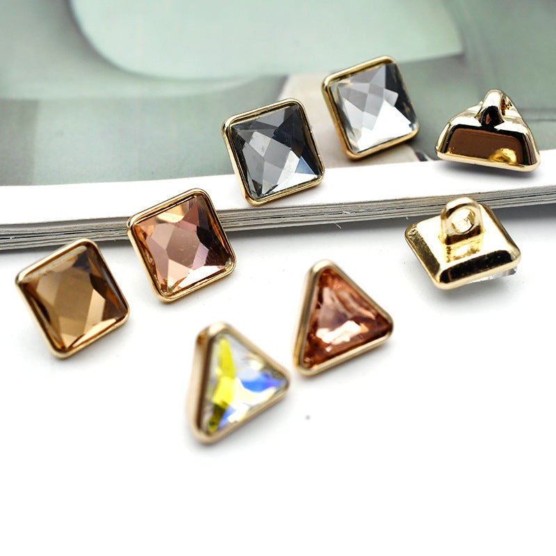 Gold-tone cuff buttons with mixed square and triangle glass stones in smoky and clear tones