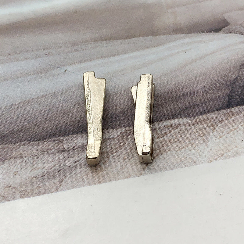 Pair of metal #5 zipper slider retainers with insertion pin tabs
