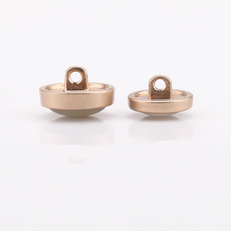 Cat-eye shank buttons, back view with center hole and ring mount, gold tone