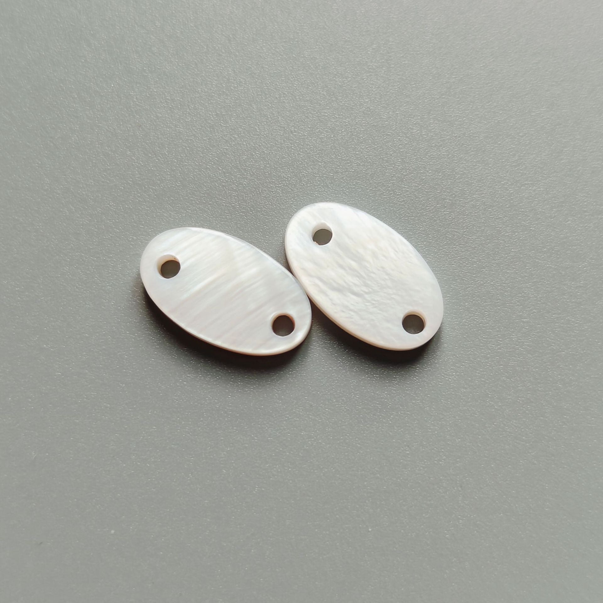 Natural white oval shell button pair with two holes, 32/34L