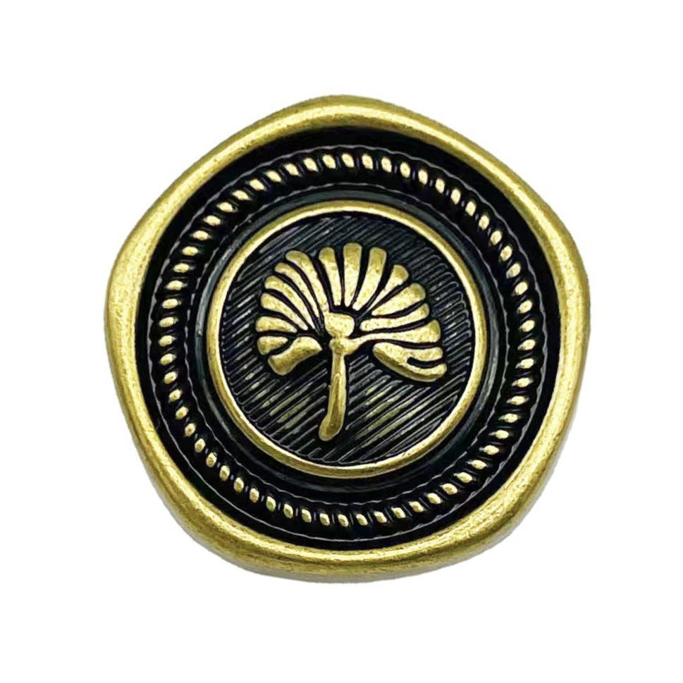 Gold pentagon metal button with black enamel center and apricot leaf crest