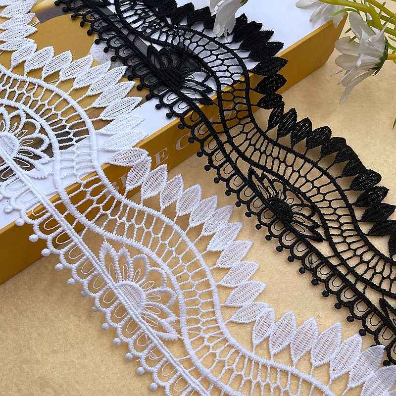 Black embroidered lace trim with scalloped edges and floral medallion, 10 cm