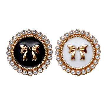 Bowknot pearl metal buttons: one black, one white with gold bow motif and pearl border