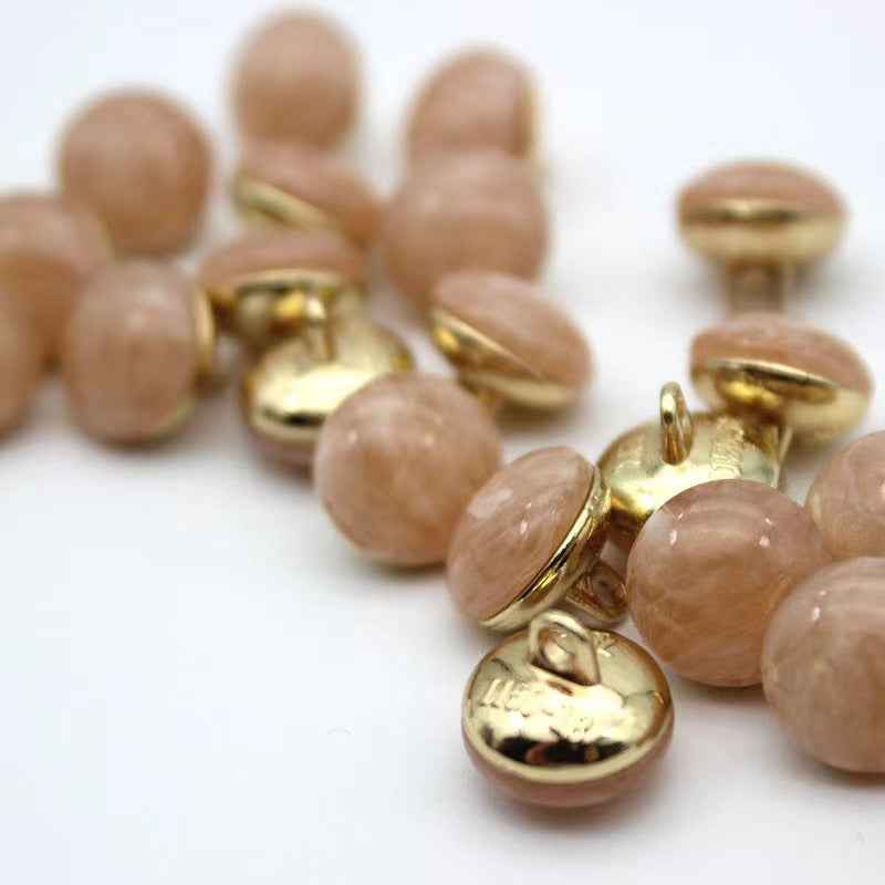 Peach/pink cat-eye shank buttons with gold loop backs, round, mixed set