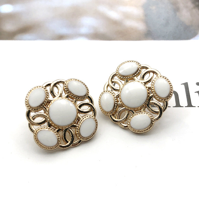 Square metal shank pearl buttons with white round pearl centers and gold-tone accents