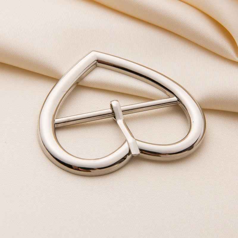 Silver heart-shaped roller buckle with rotating bar and central prong