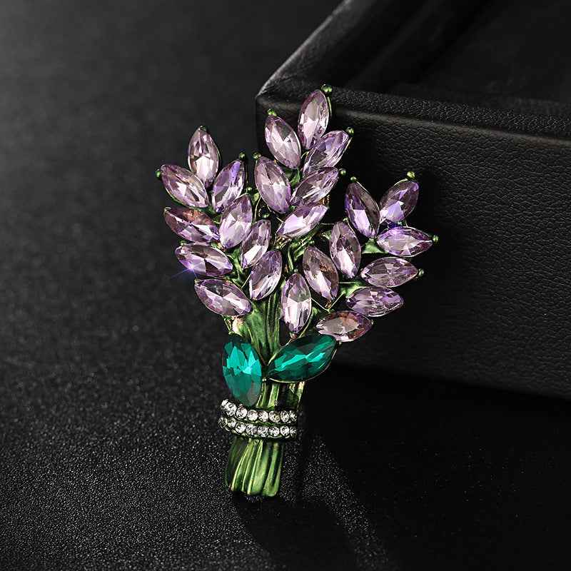 Lavender crystal flower brooch pin with teal emerald accents and pavé band