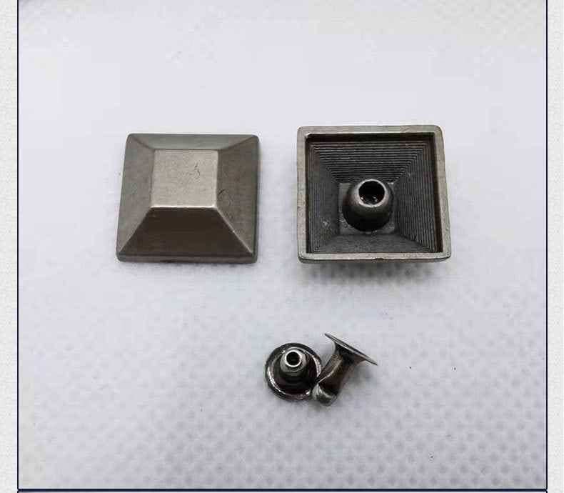 Square-back pyramid studs with central hole and ridged texture on alloy
