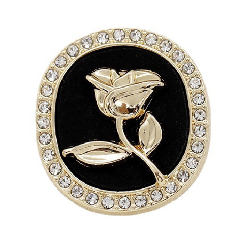 Black round rhinestone rose metal shank button with gold-tone crystal border