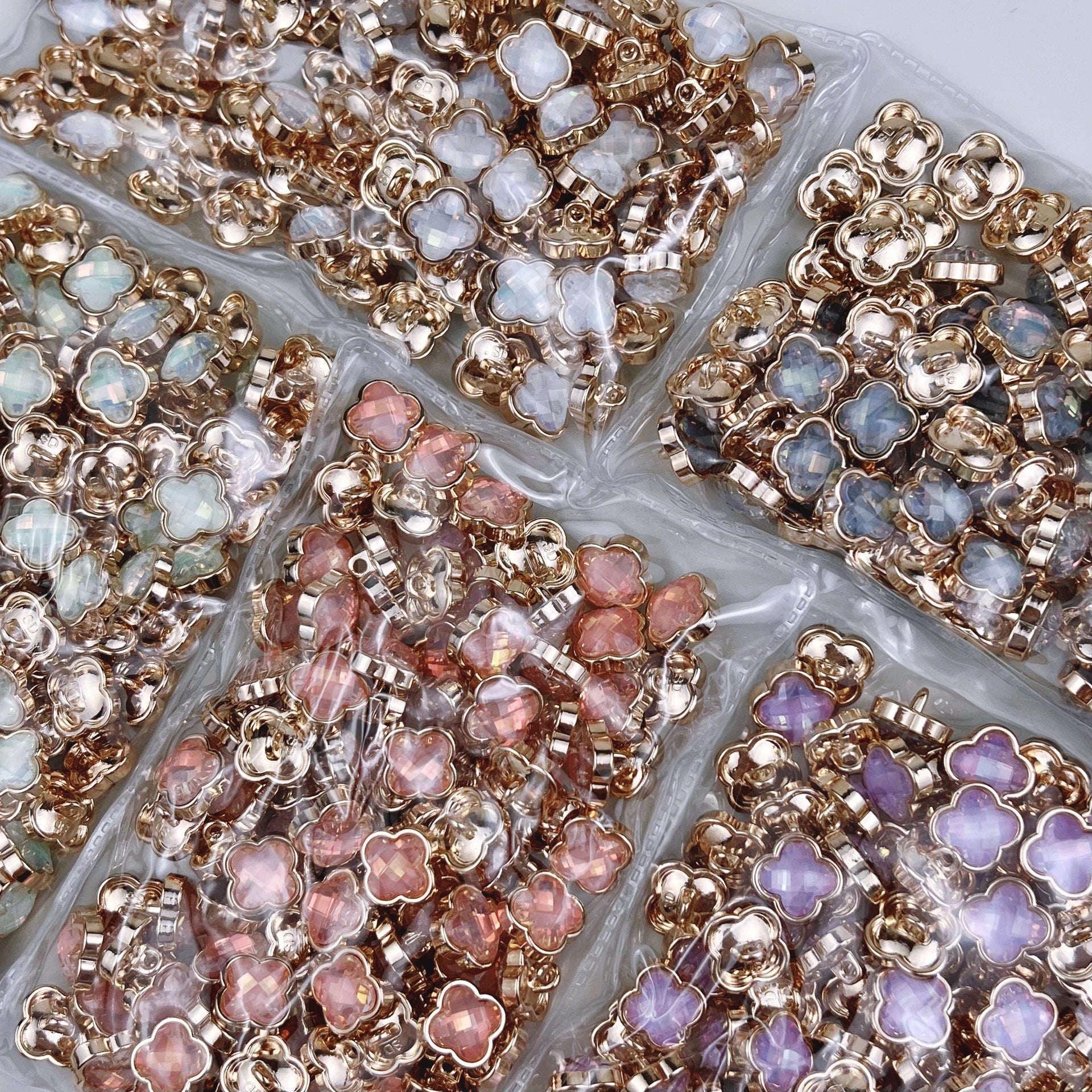 Four-leaf clover metal buttons assortment with iridescent stones, mixed colors
