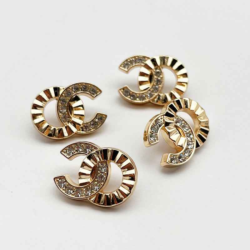 Set of rhinestone C-shaped shank metal buttons, gold-tone with clear stones