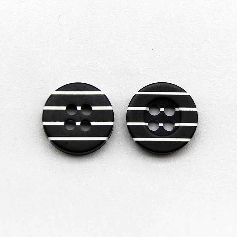 Pair of black resin buttons with white horizontal stripes and four holes
