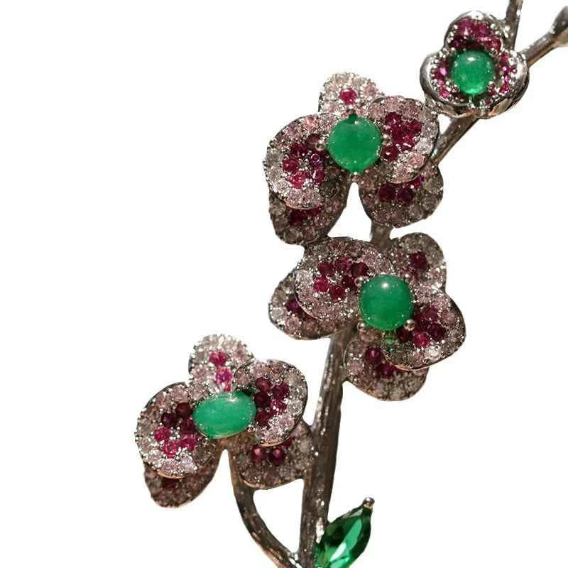 Plum blossom brooch pin, green round stones with ruby-red crystal ring, leaf detail