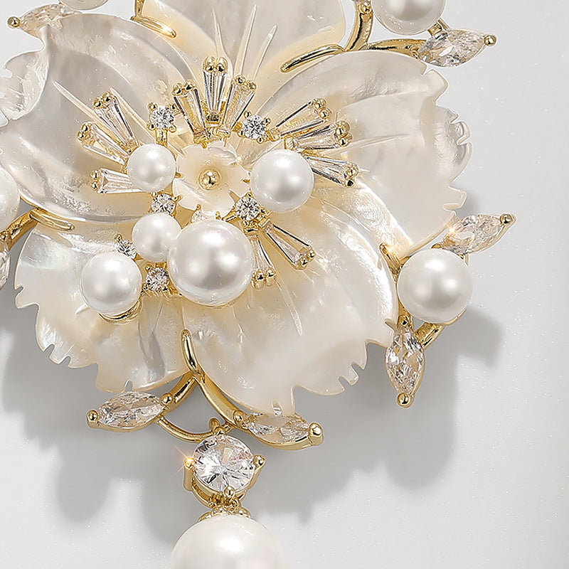 Close-up camellia pearl brooch: white pearls and clear zirconia on layered petals