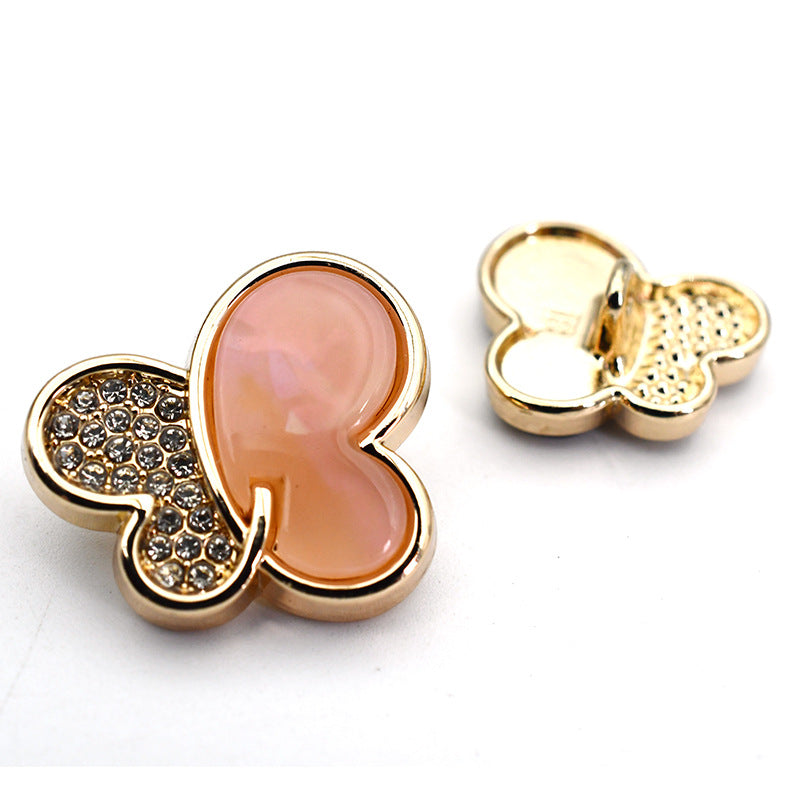 Pink butterfly rhinestone shank button with gold-tone metal shank