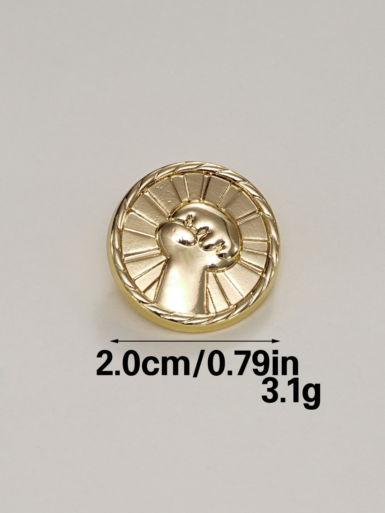 Gold round fist button with metal shank and textured back, raised design