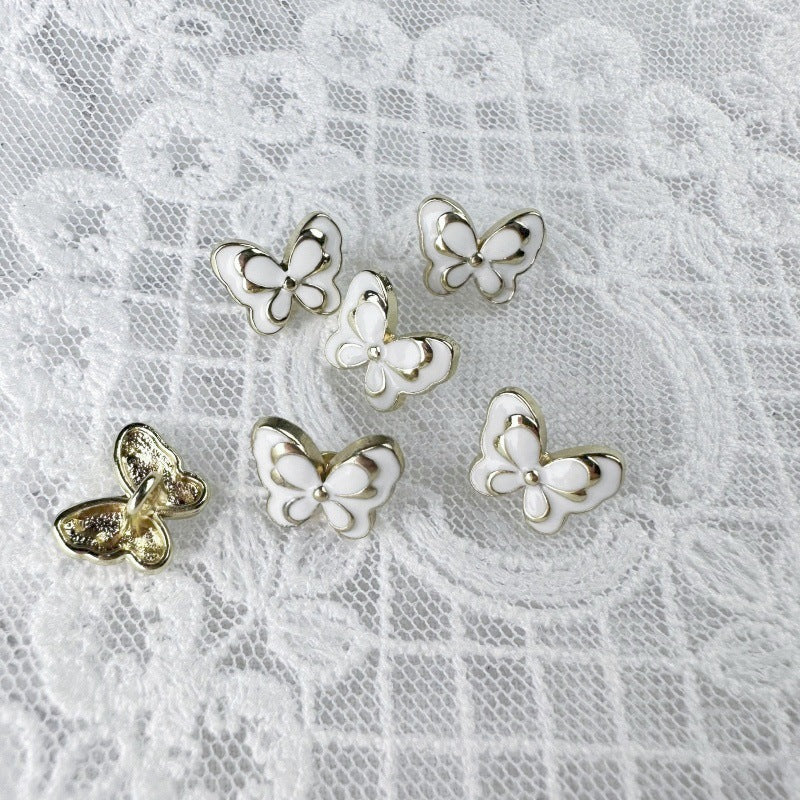 White butterfly metal buttons with gold-toned edging and back loop, 12mm