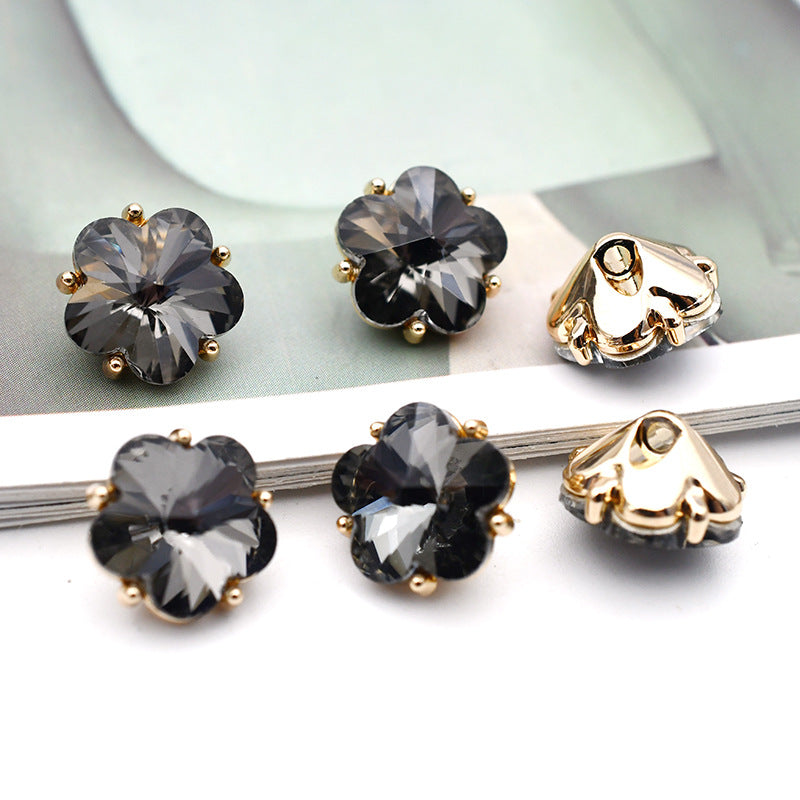 Small flower glass rhinestone shank buttons, dark gray flower faces with gold-tone settings and metal shanks